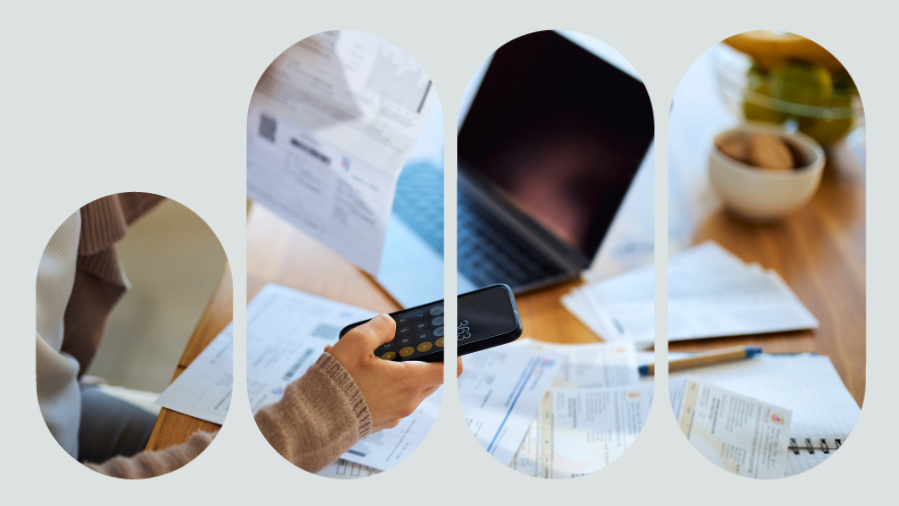 mão digitando calculadora no celular com papeis e computador ao fundo